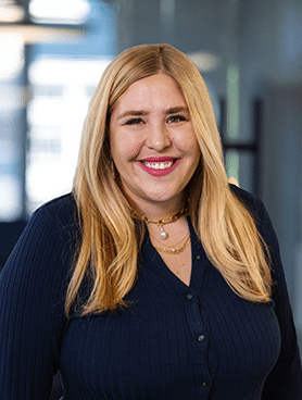 Headshot of the Vice President of Client Services at Campaign Solutions, Maggie Paulin.She is smiling in a blue blouse.